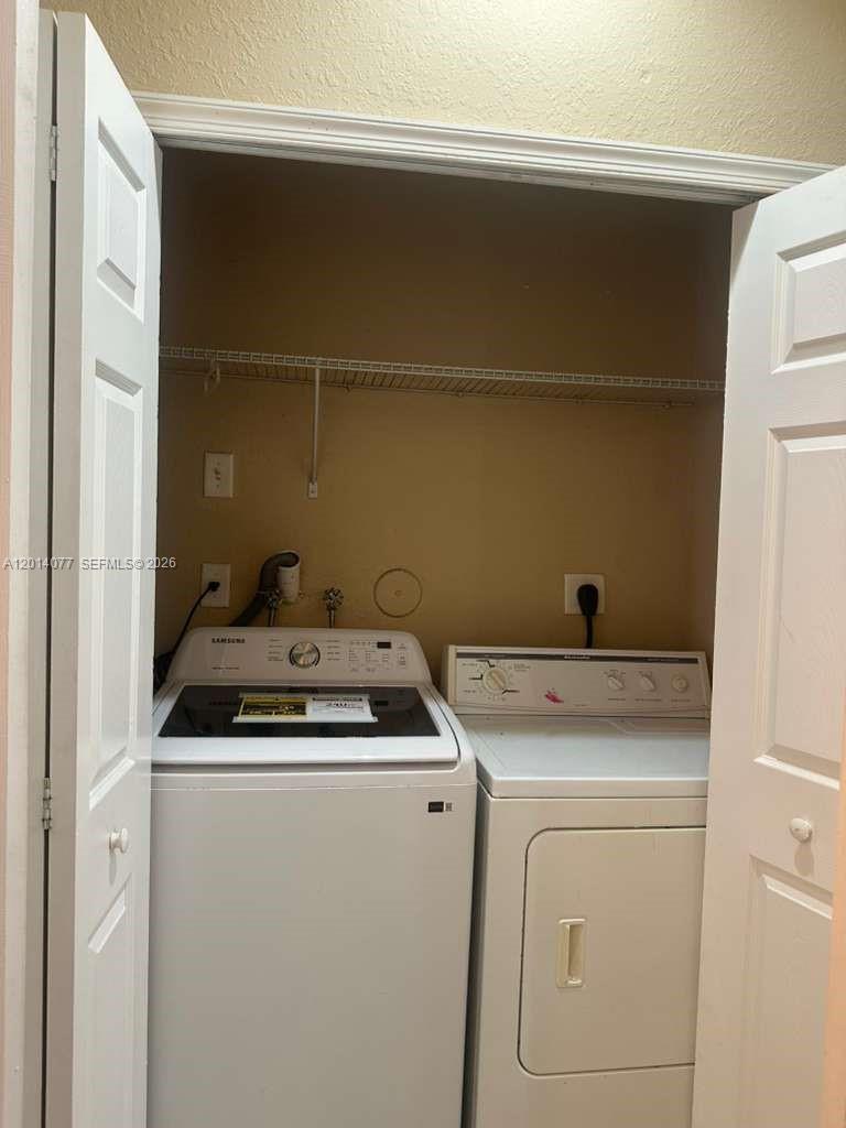 2913 Southeast 15th Road, Unit 64 Homestead, FL 33035 - Photo 8 of 14 a utility room with dryer and washer