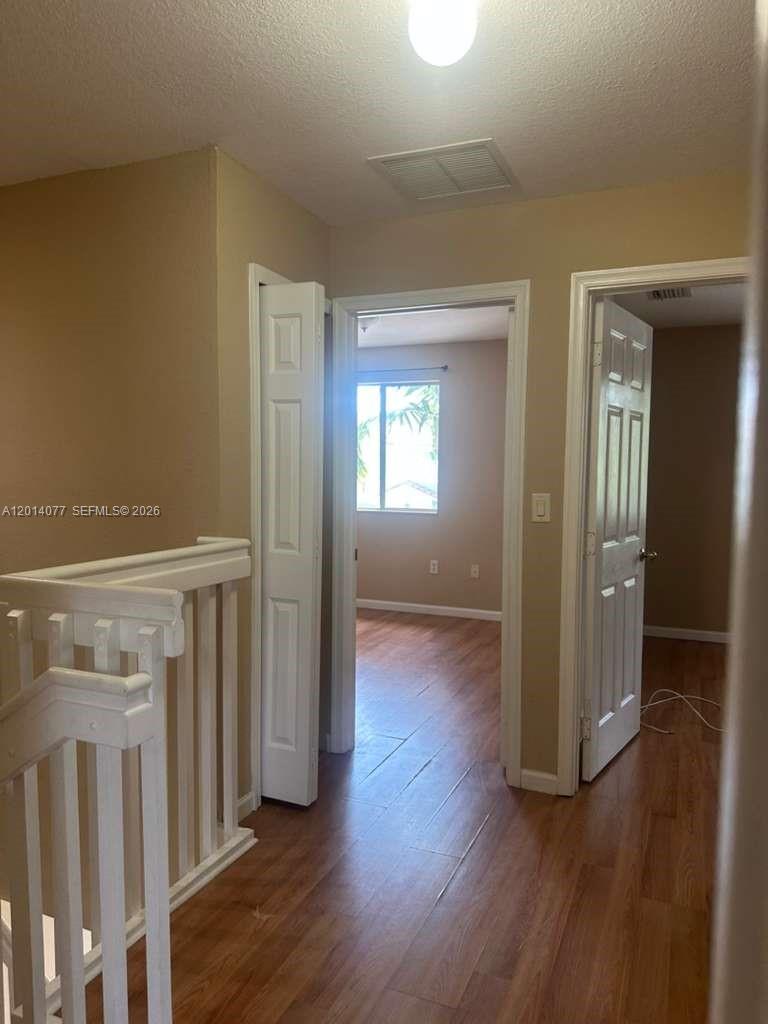2913 Southeast 15th Road, Unit 64 Homestead, FL 33035 - Photo 9 of 14 a view of a hallway with wooden floor and stairs