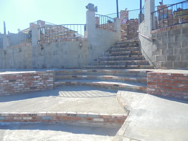 a view of a terrace with chairs and a table