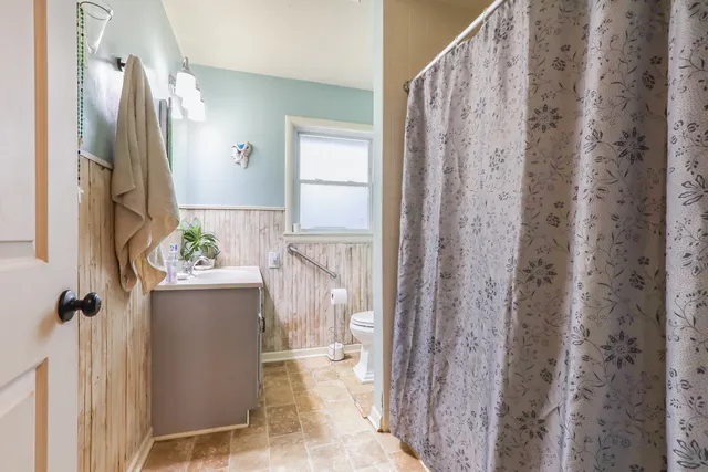 a view of a walk in closet and bathroom