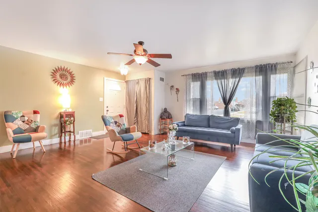 a living room with furniture and wooden floor