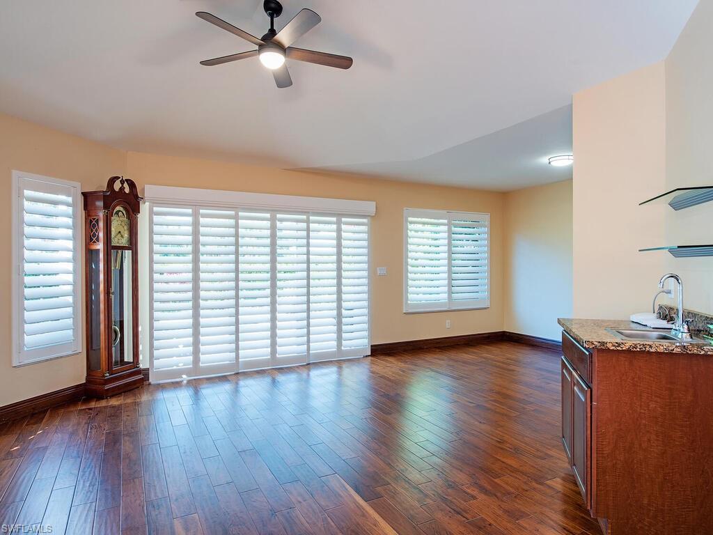 808 Rue Deville, Unit 35 Naples, FL 34108 - Photo 8 of 20 Living area with a ceiling fan and dark wood finished floors