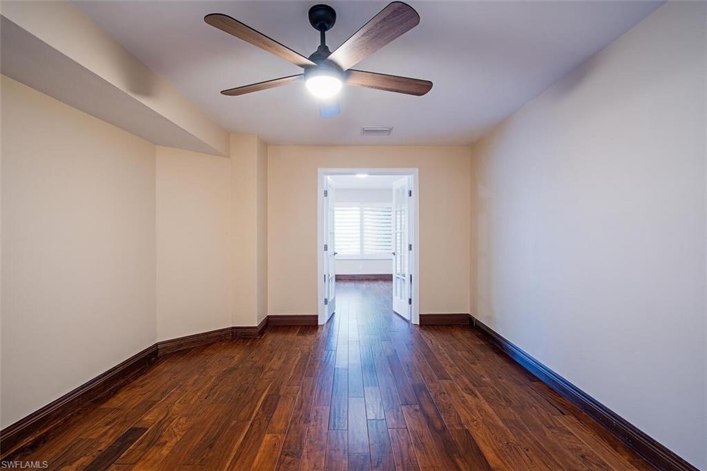 808 Rue Deville, Unit 35 Naples, FL 34108 - Photo 10 of 20 1st floor primary ensuite with french doors opening to the den