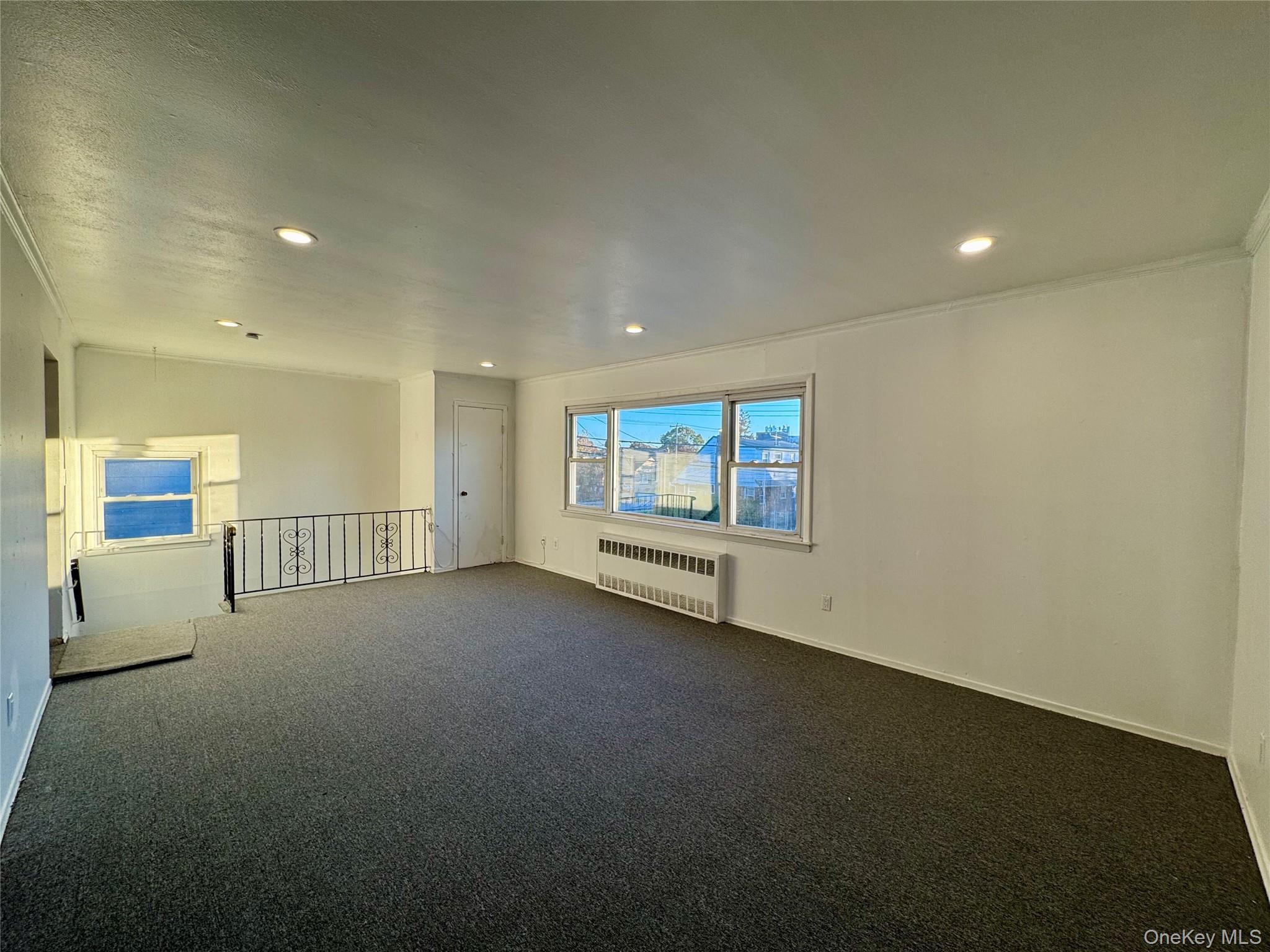 58 Cohill Road, Unit 2 Valley Stream, NY 11580 - Photo 4 of 23 an empty room with windows and fireplace