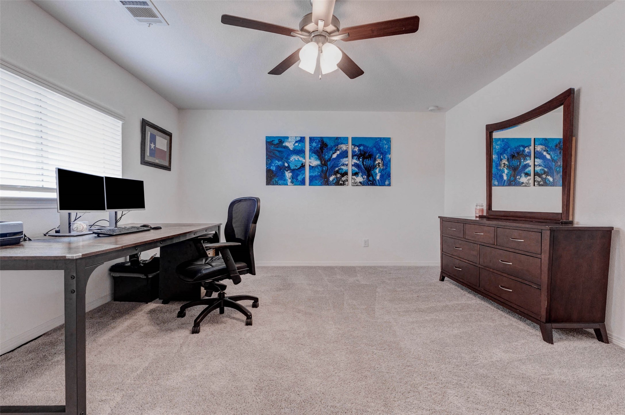 32418 Fly Fish Way Fulshear, TX 77441 - Photo 29 of 40 This second view of the bedroom showcases just how spacious the room truly is, with plenty of floor space to comfortably accommodate a full bedroom suite alongside a dedicated work or study area.