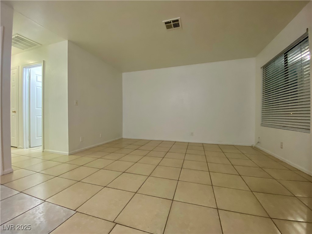 5284 Hagemann Lane, Unit D Las Vegas, NV 89110 - Photo 14 of 30 Spare room with light tile patterned floors