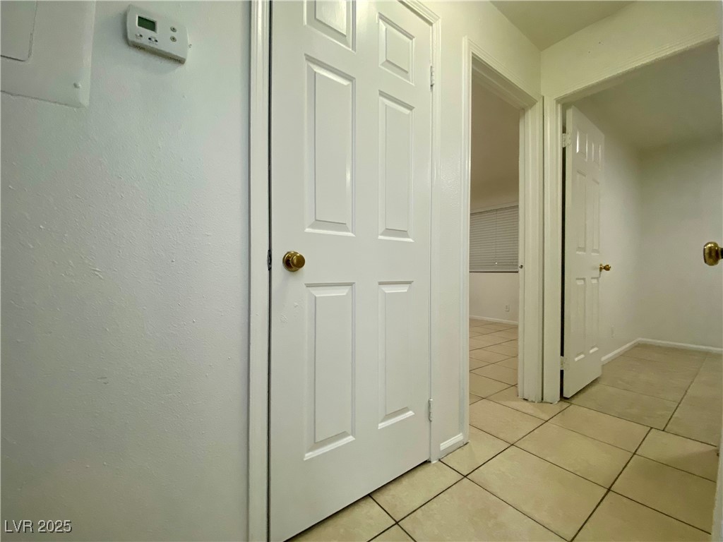 5284 Hagemann Lane, Unit D Las Vegas, NV 89110 - Photo 16 of 30 Corridor with light tile patterned flooring and baseboards