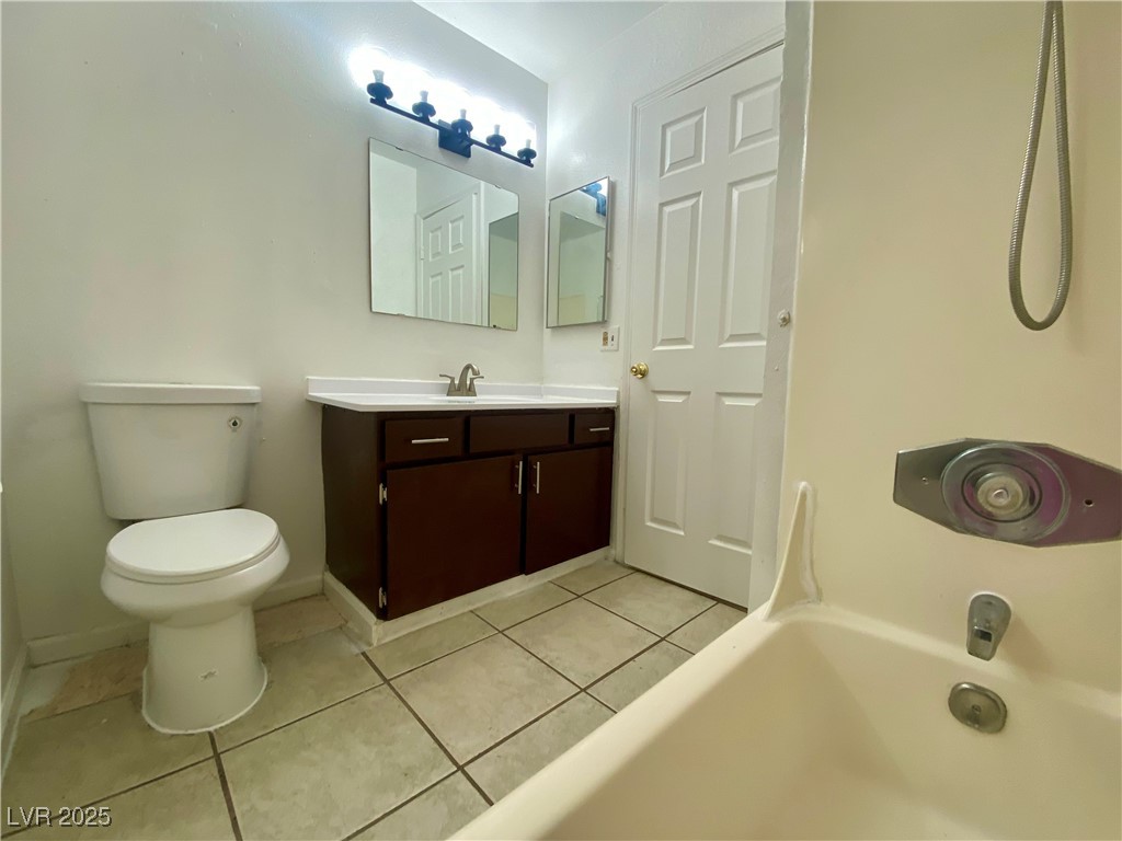 5284 Hagemann Lane, Unit D Las Vegas, NV 89110 - Photo 19 of 30 Full bath with light tile patterned floors and vanity