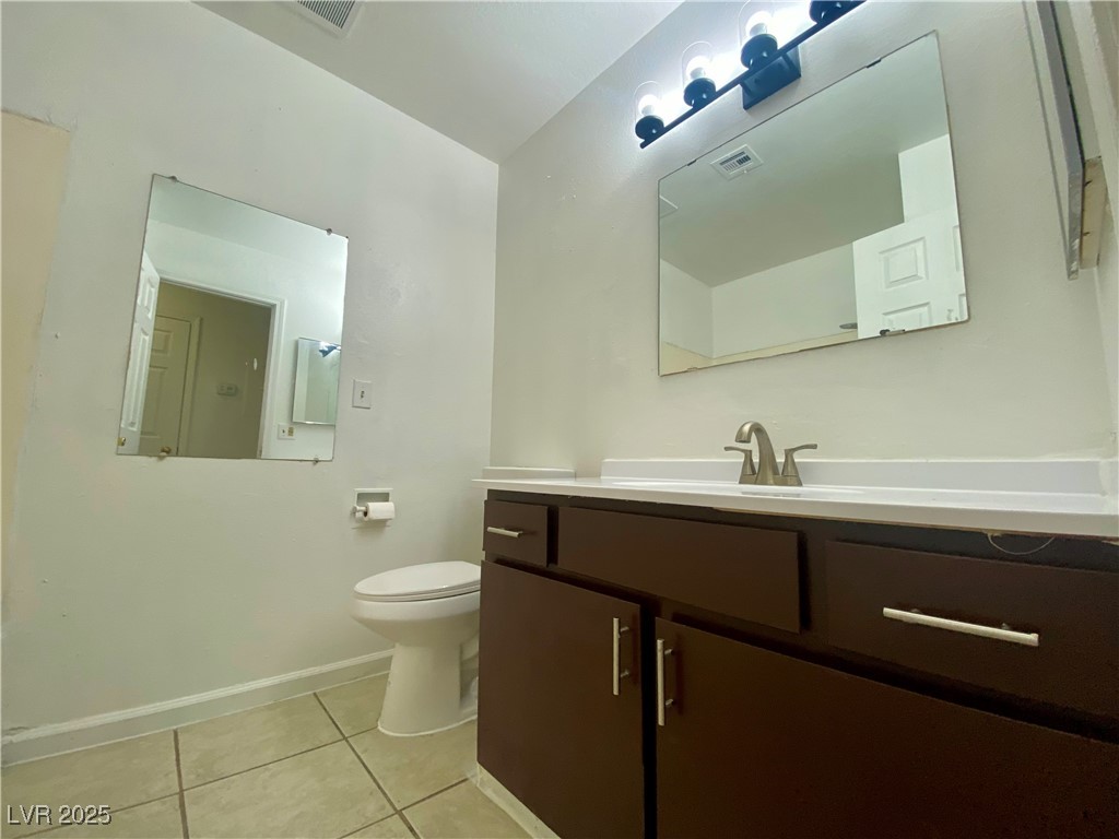 5284 Hagemann Lane, Unit D Las Vegas, NV 89110 - Photo 20 of 30 Half bathroom featuring light tile patterned floors and vanity