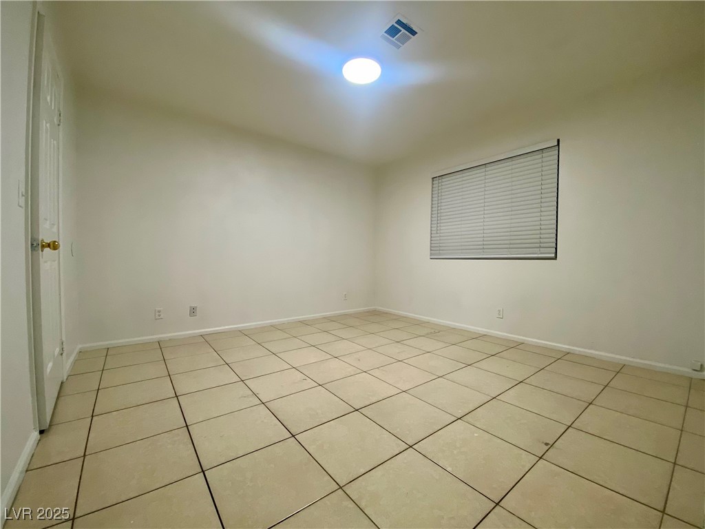 5284 Hagemann Lane, Unit D Las Vegas, NV 89110 - Photo 23 of 30 Unfurnished room featuring light tile patterned flooring and baseboards