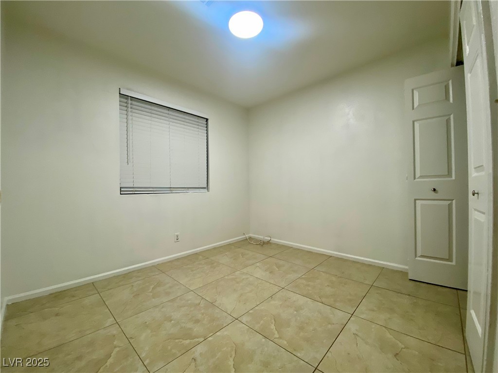 5284 Hagemann Lane, Unit D Las Vegas, NV 89110 - Photo 24 of 30 Empty room featuring baseboards and light tile patterned flooring