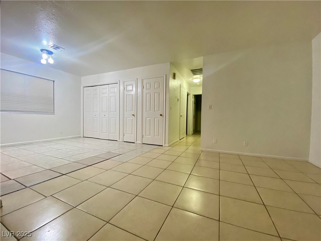 5284 Hagemann Lane, Unit D Las Vegas, NV 89110 - Photo 10 of 30 Unfurnished bedroom featuring light tile patterned floors and a closet