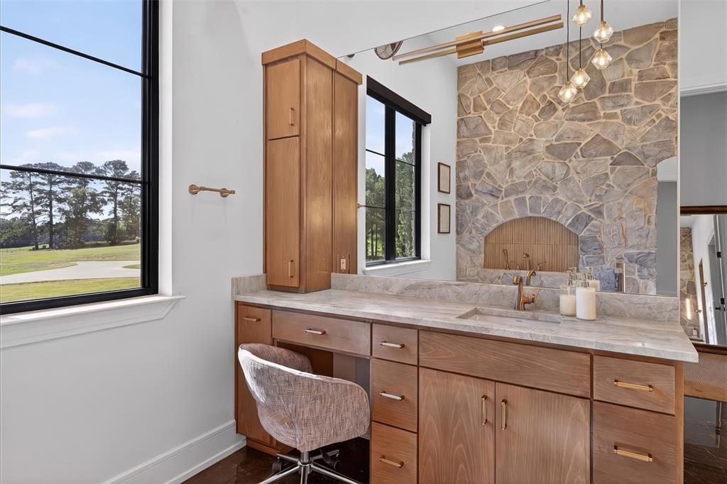 2804 Buchanan Road Hallsville, TX 75650 - Photo 20 of 40 a bathroom with a granite countertop sink a mirror and a shower