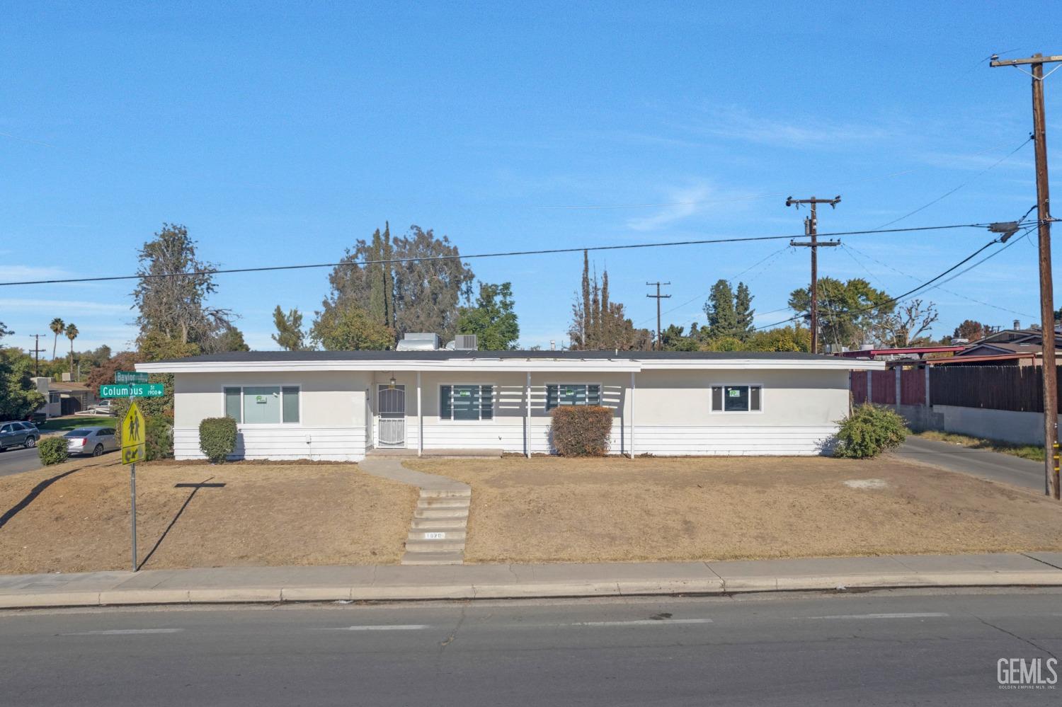a front view of a house with a garden