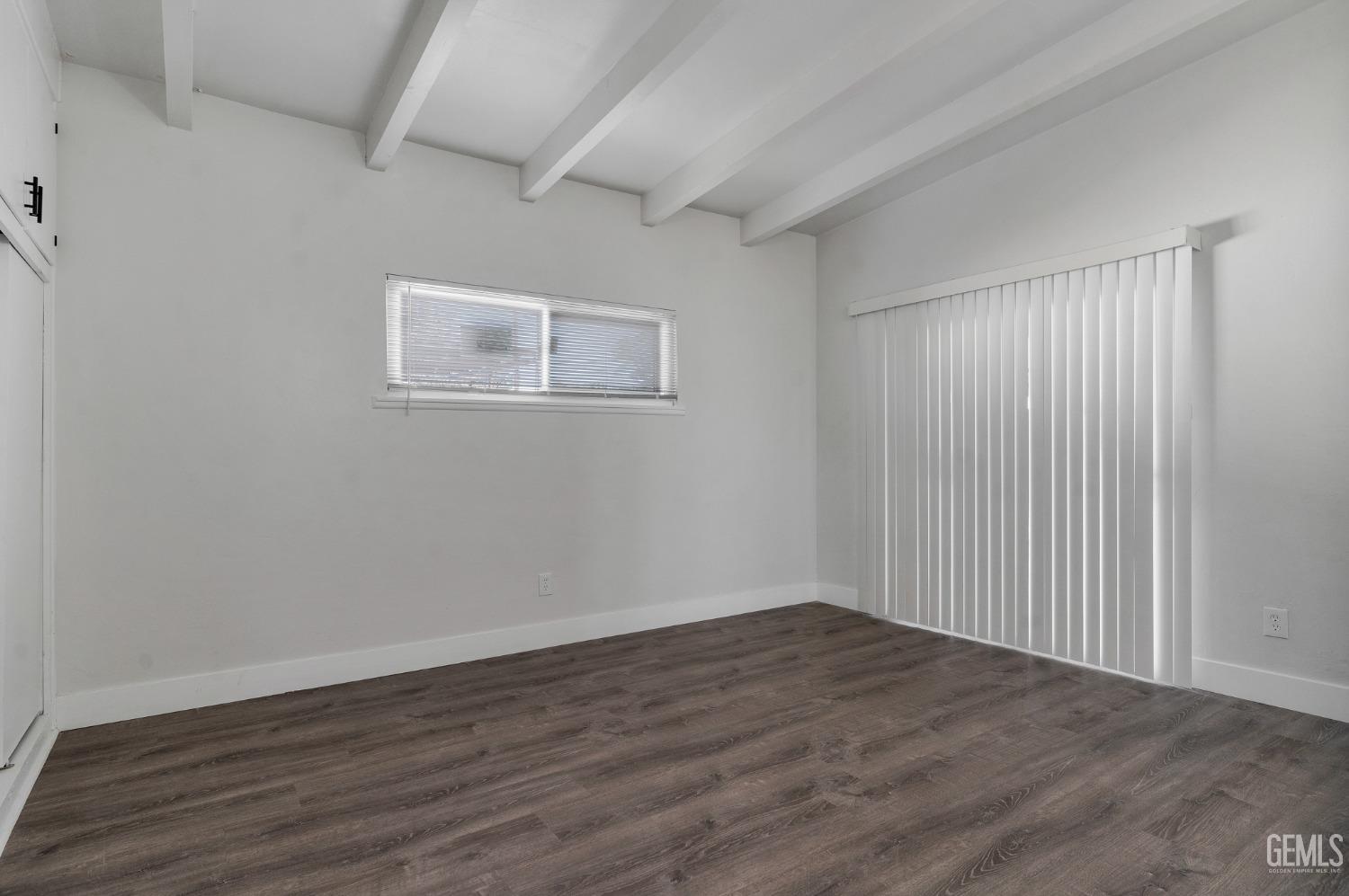 Undisclosed Address Bakersfield, CA 93305 - Photo 11 of 23 a view of an empty room with wooden floor and a window