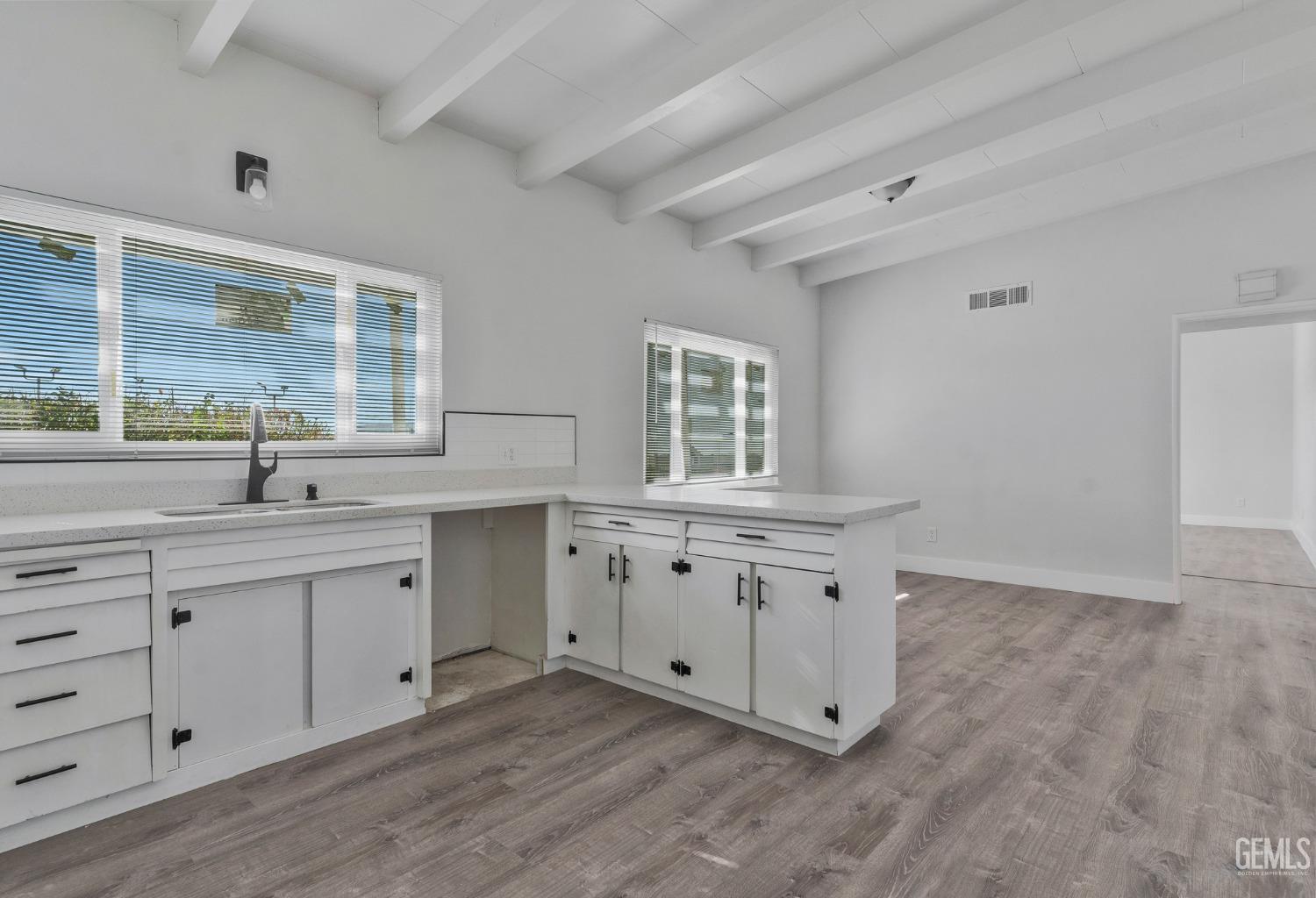 Undisclosed Address Bakersfield, CA 93305 - Photo 20 of 23 a view with cabinets and wooden floor