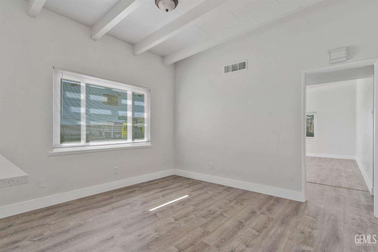 Undisclosed Address Bakersfield, CA 93305 - Photo 21 of 23 an empty room with wooden floor and windows