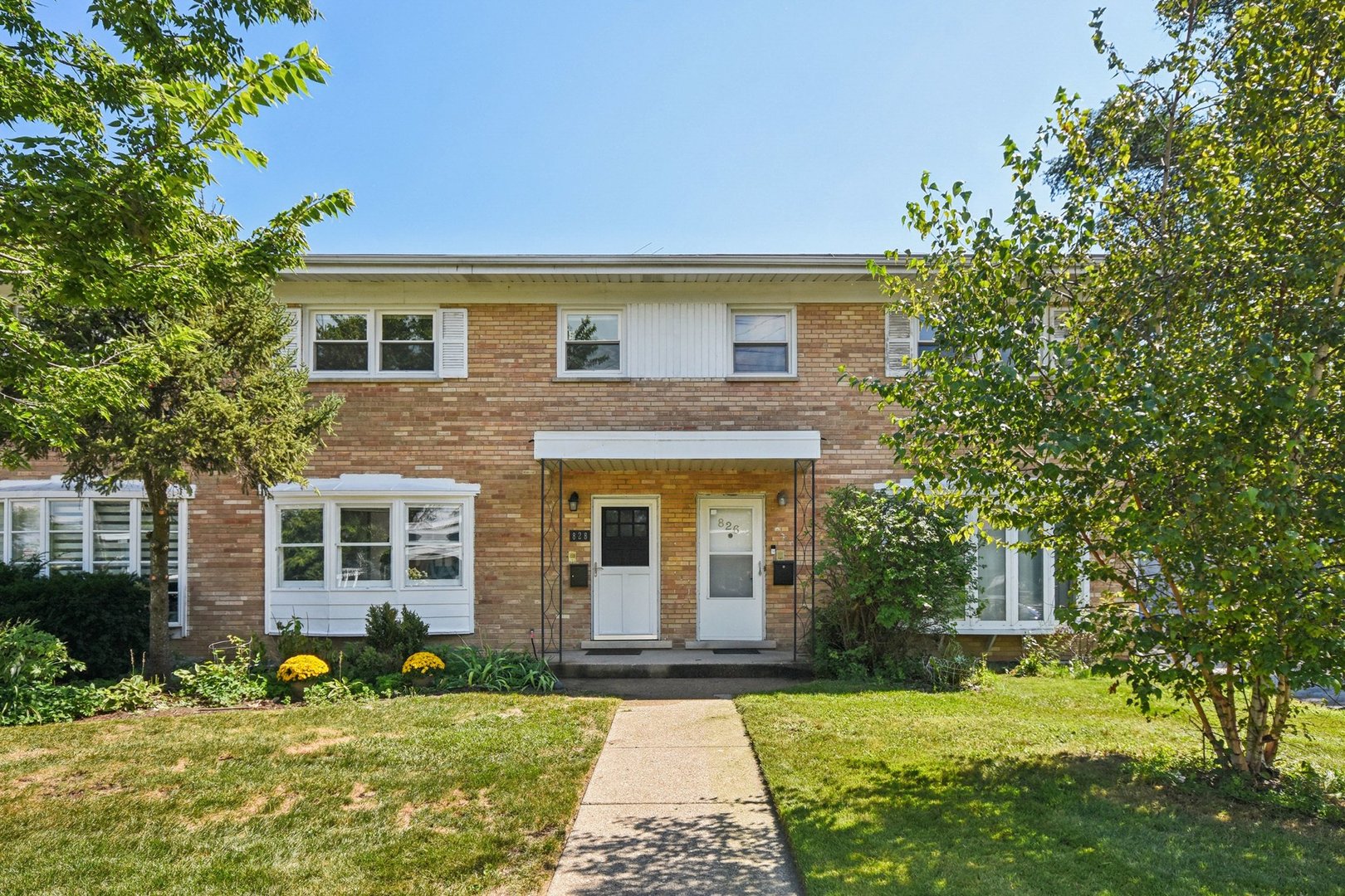 828 Lavergne Avenue Wilmette, IL 60091 - Photo 1 of 19 a front view of a house with a yard and garage