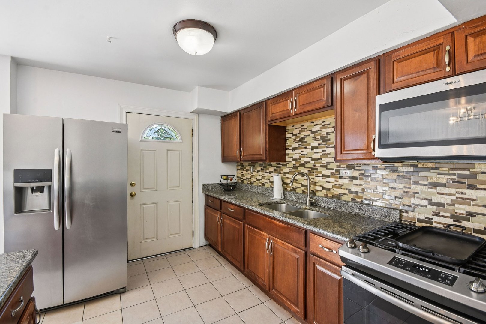 828 Lavergne Avenue Wilmette, IL 60091 - Photo 5 of 19 a kitchen with stainless steel appliances granite countertop a stove a refrigerator and a sink