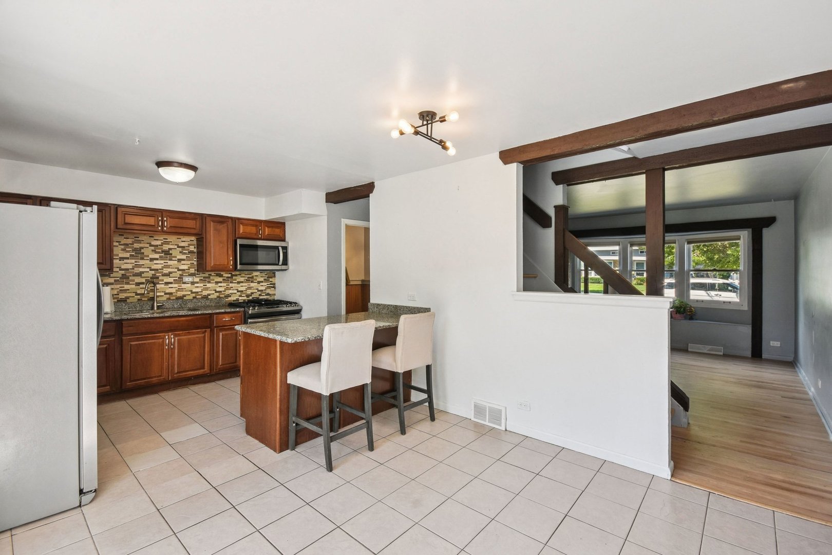 828 Lavergne Avenue Wilmette, IL 60091 - Photo 6 of 19 a kitchen with a sink and chairs