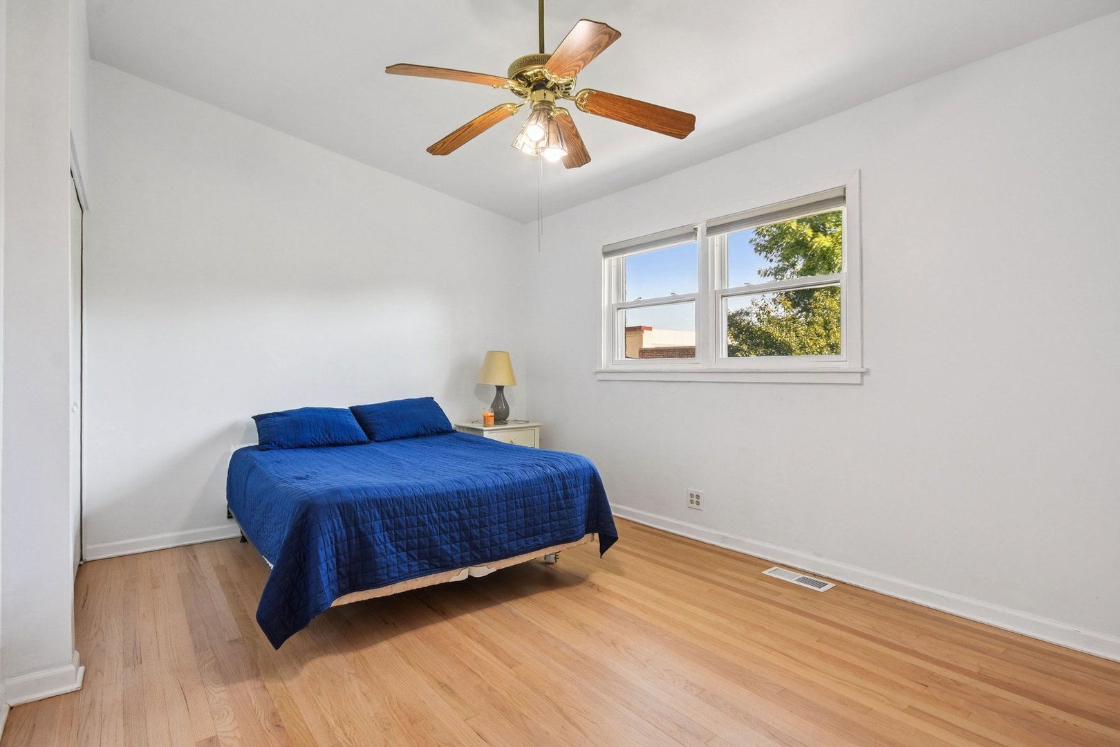 828 Lavergne Avenue Wilmette, IL 60091 - Photo 9 of 19 a bedroom with a bed and a chandelier