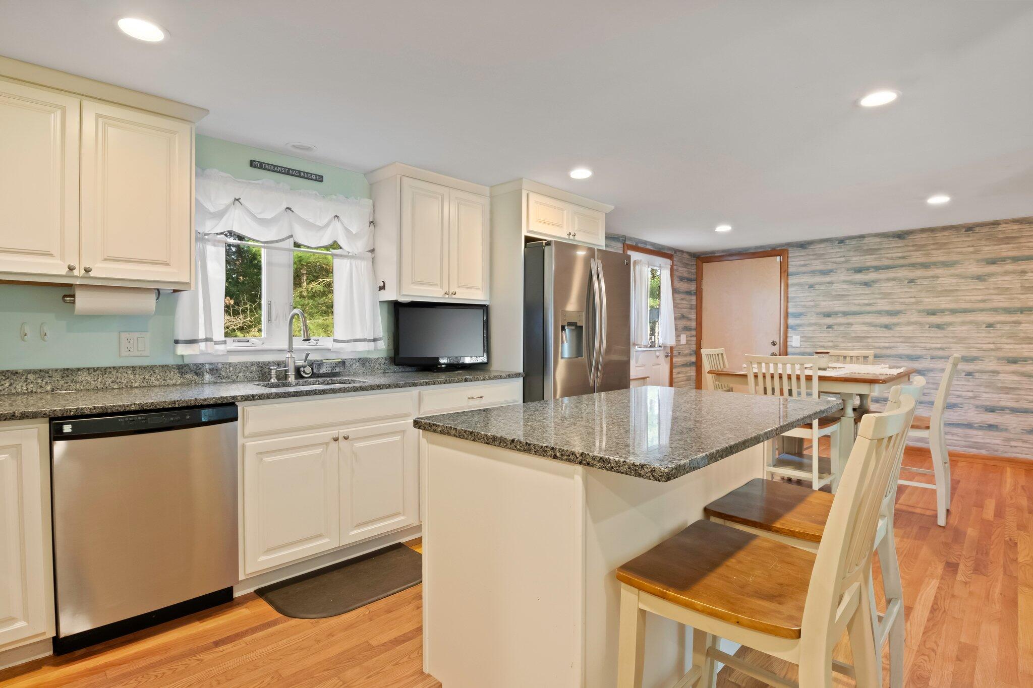 270 Mashpee Neck Road Mashpee, MA 02649 - Photo 11 of 36 a kitchen with stainless steel appliances granite countertop a sink a stove and cabinets