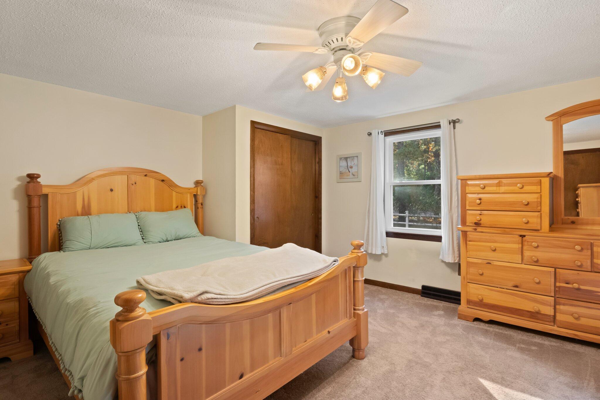 270 Mashpee Neck Road Mashpee, MA 02649 - Photo 17 of 36 a bedroom with a bed and a dresser