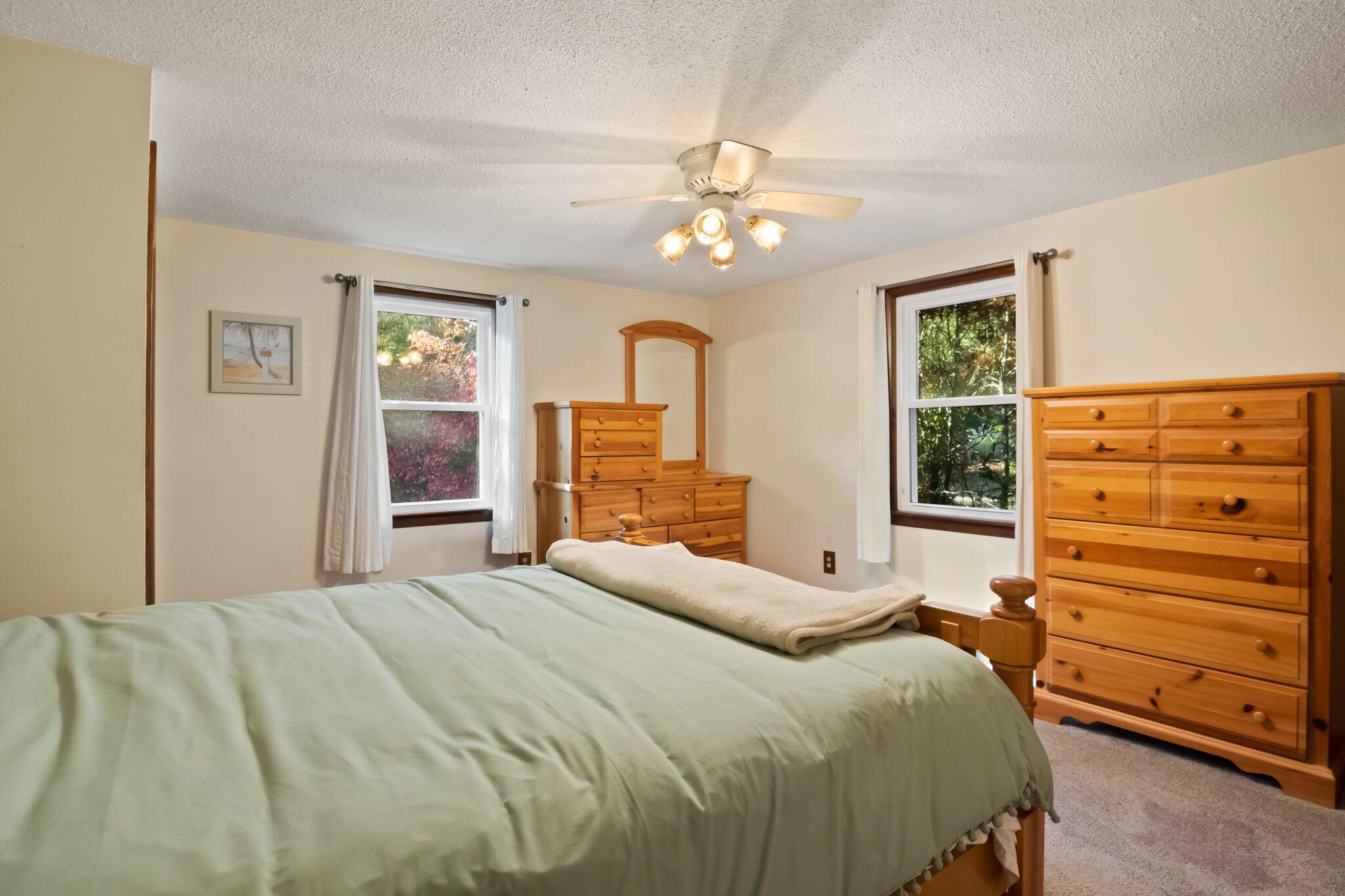 270 Mashpee Neck Road Mashpee, MA 02649 - Photo 18 of 36 a bedroom with a bed and a dresser