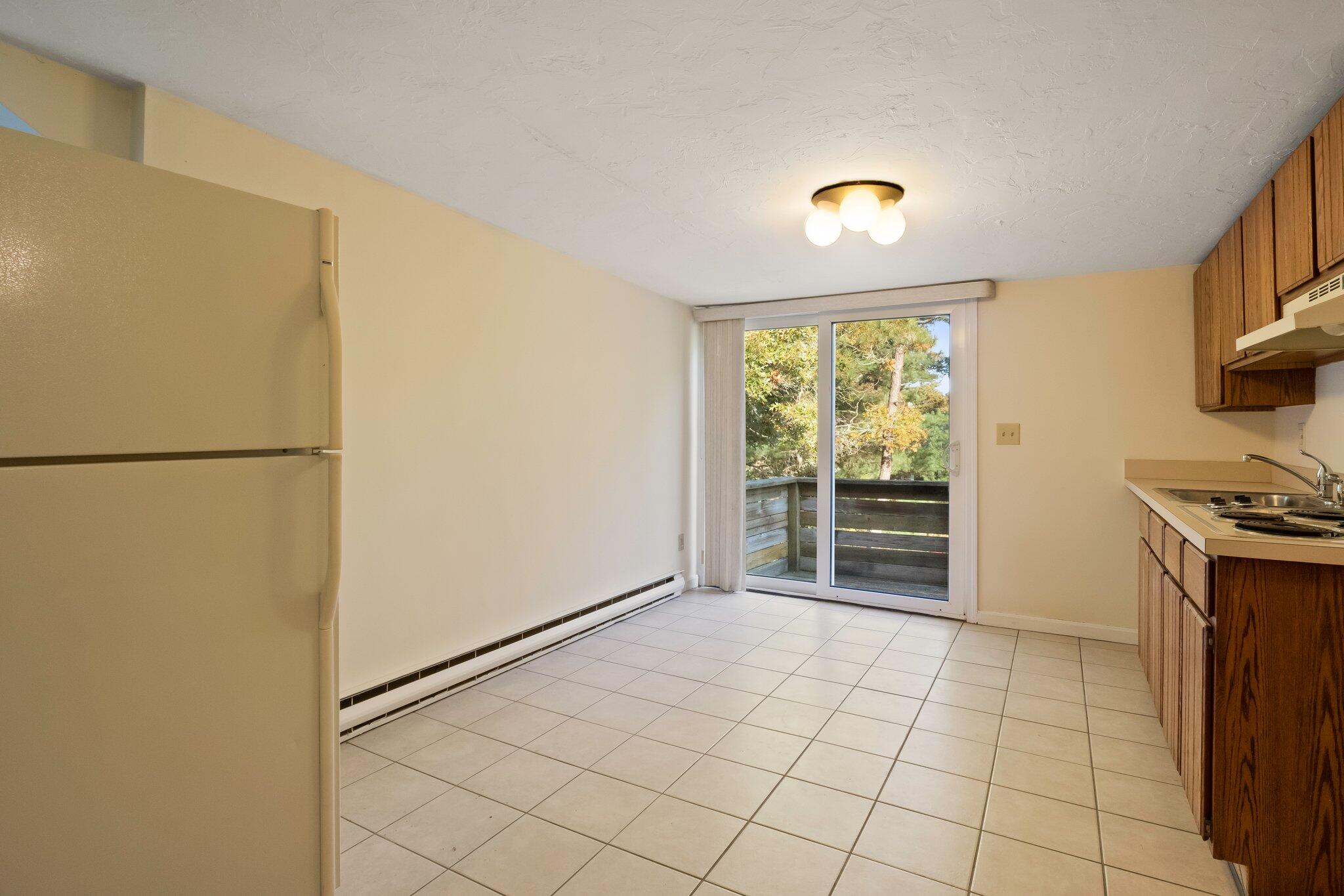 270 Mashpee Neck Road Mashpee, MA 02649 - Photo 19 of 36 a view of a kitchen with an empty space and a window