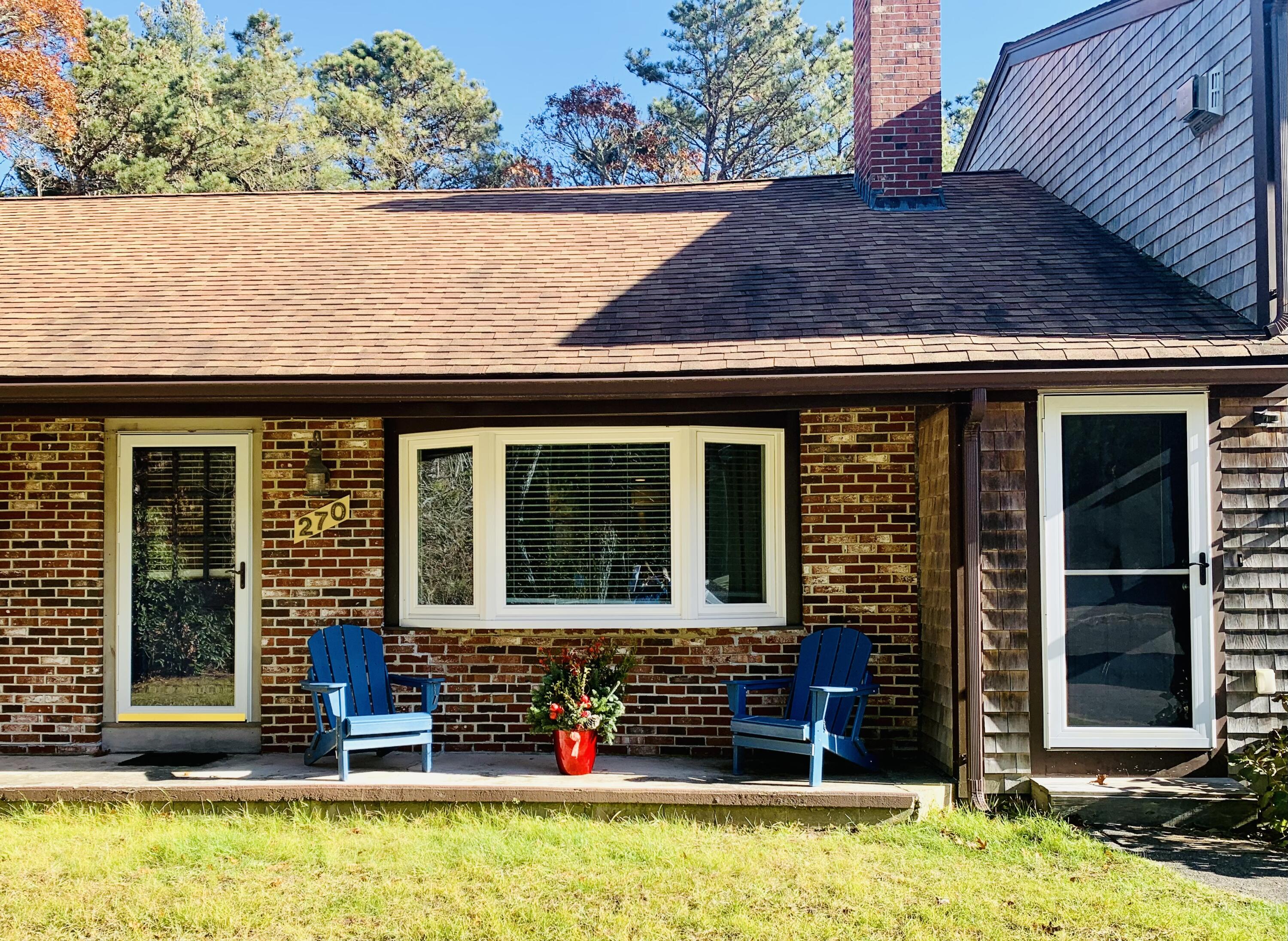 270 Mashpee Neck Road Mashpee, MA 02649 - Photo 2 of 36 front view of a house with a yard