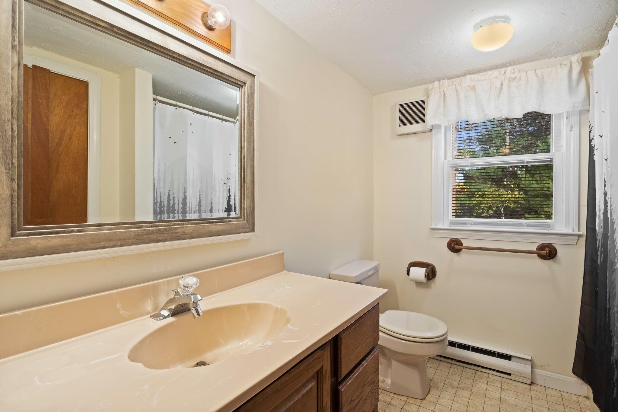 270 Mashpee Neck Road Mashpee, MA 02649 - Photo 22 of 36 a bathroom with a sink a toilet and shower