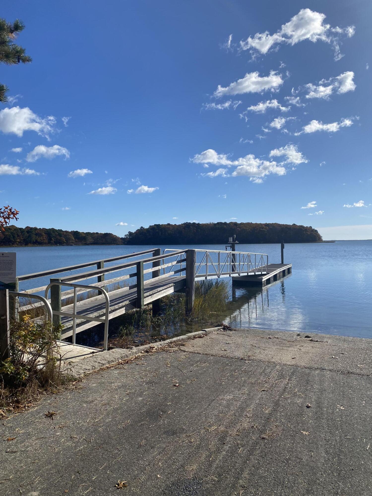 270 Mashpee Neck Road Mashpee, MA 02649 - Photo 28 of 36 a view of a backyard with lawn chairs and iron fence