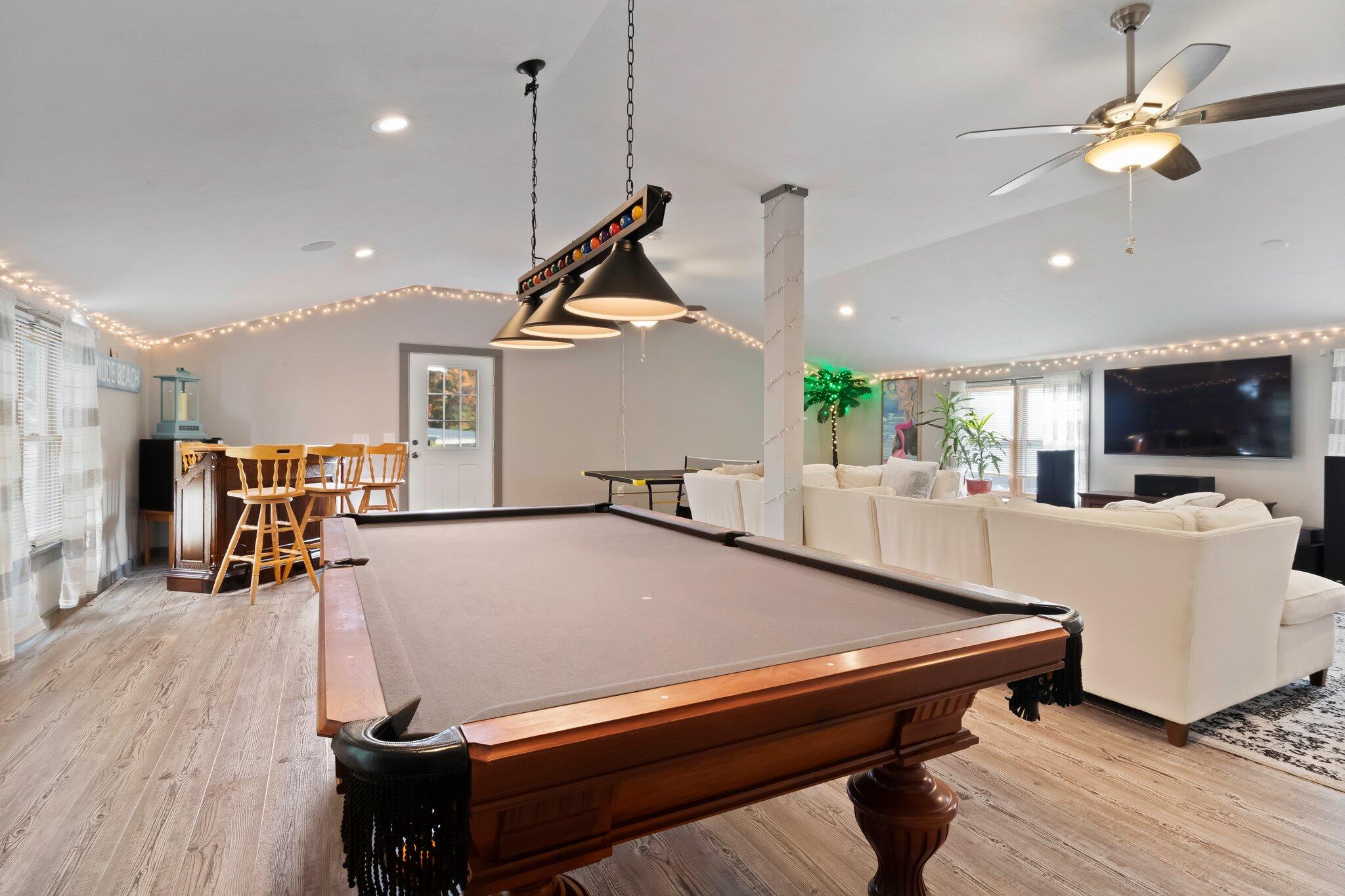 270 Mashpee Neck Road Mashpee, MA 02649 - Photo 4 of 36 a living room with furniture a wooden floor and a chandelier