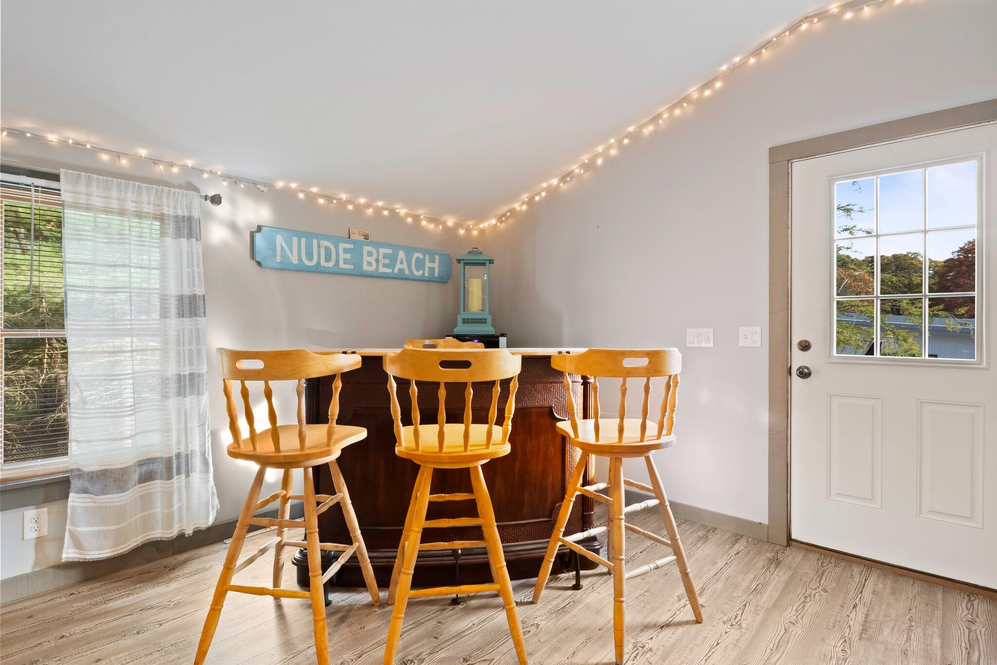 270 Mashpee Neck Road Mashpee, MA 02649 - Photo 7 of 36 a view of a dining room with furniture and wooden floor
