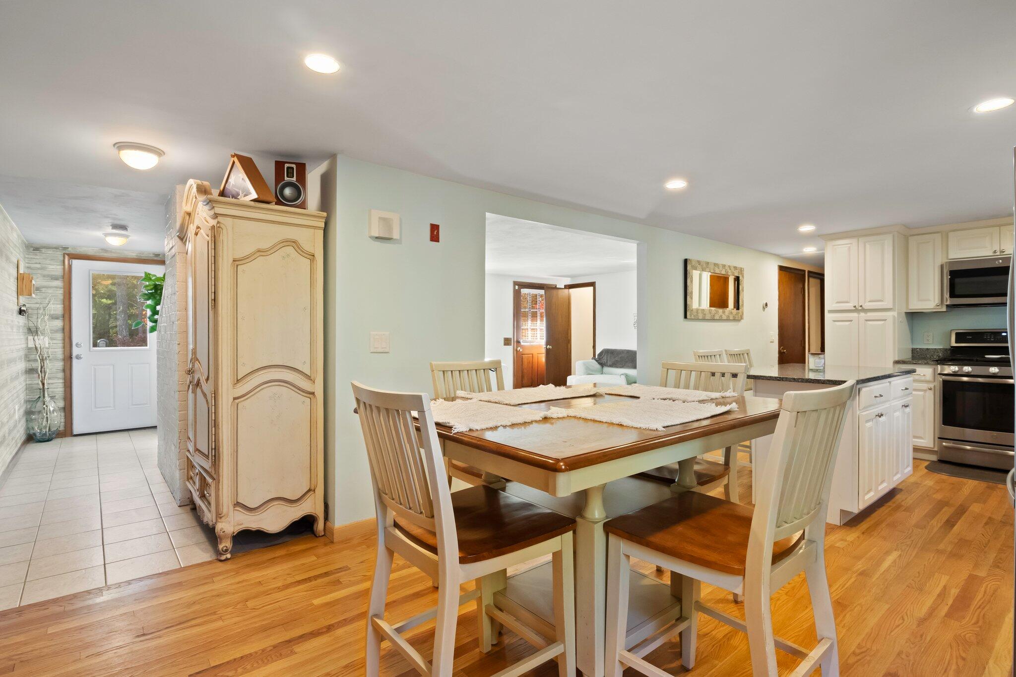 270 Mashpee Neck Road Mashpee, MA 02649 - Photo 8 of 36 a living room with stainless steel appliances granite countertop a dining table and chairs with wooden floor