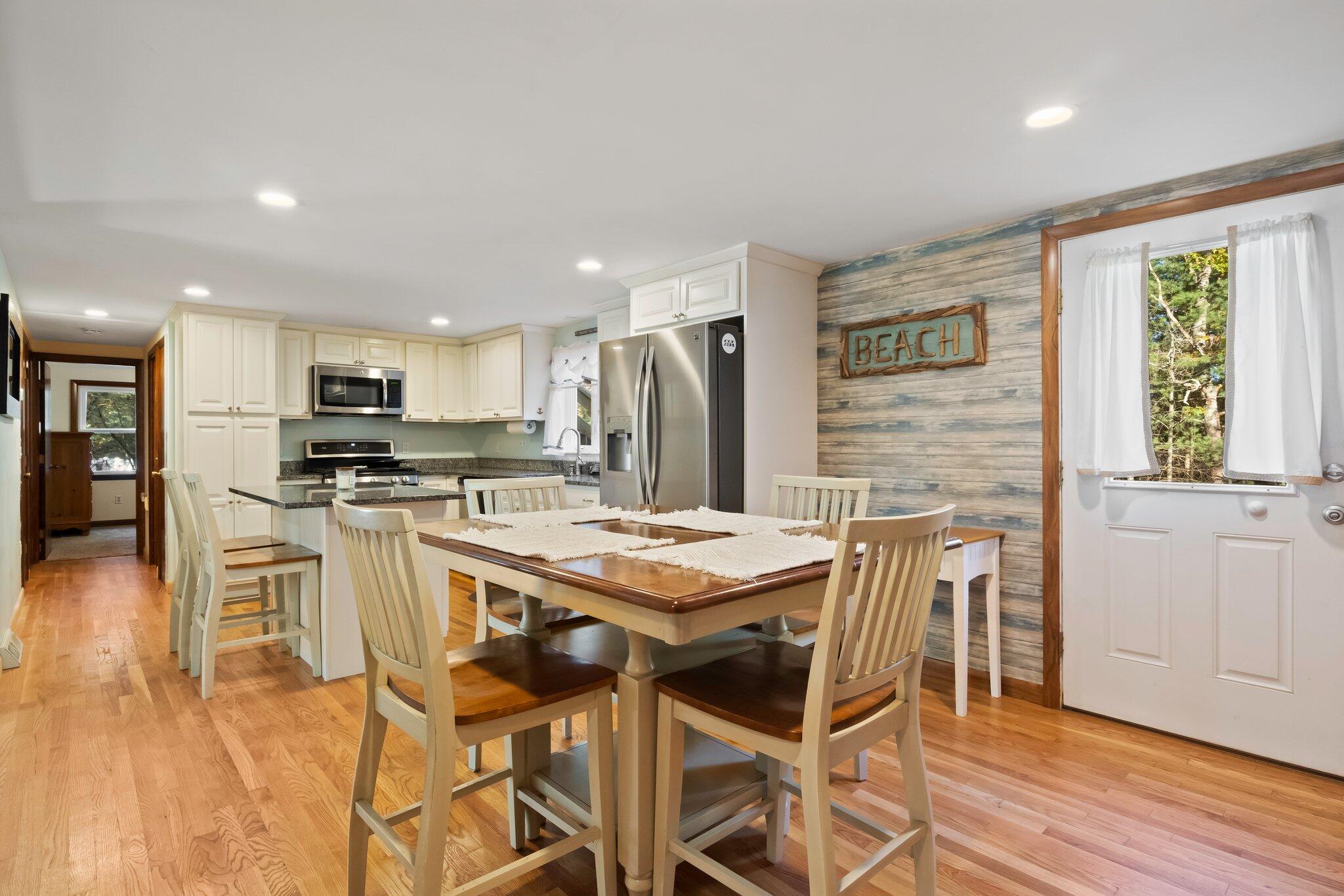 270 Mashpee Neck Road Mashpee, MA 02649 - Photo 9 of 36 a kitchen with stainless steel appliances kitchen island granite countertop a sink and cabinets