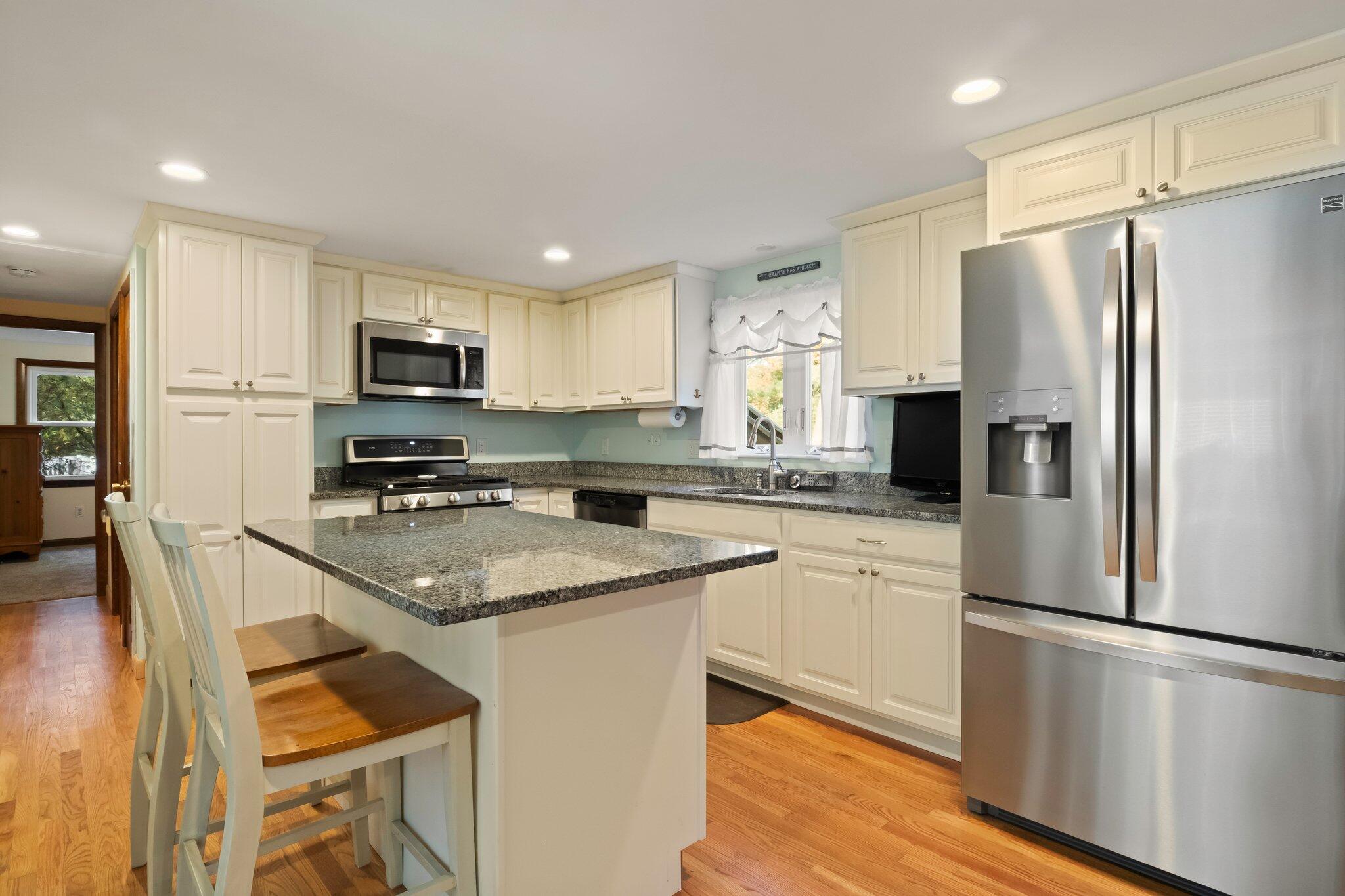270 Mashpee Neck Road Mashpee, MA 02649 - Photo 10 of 36 a kitchen with stainless steel appliances a refrigerator stove microwave and sink