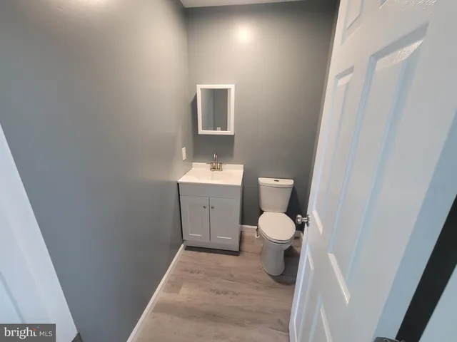 a bathroom with a toilet sink and a mirror
