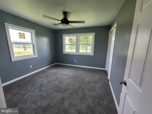 a view of room with window and ceiling fan