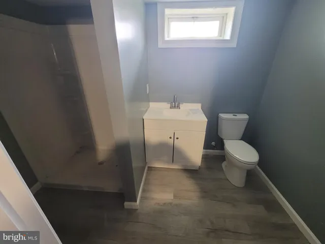 a white toilet sitting next to a small sink