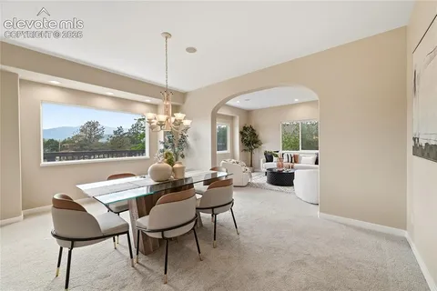 a living room with furniture and a large mirror