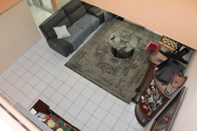 a bedroom with a bed a couch and dresser