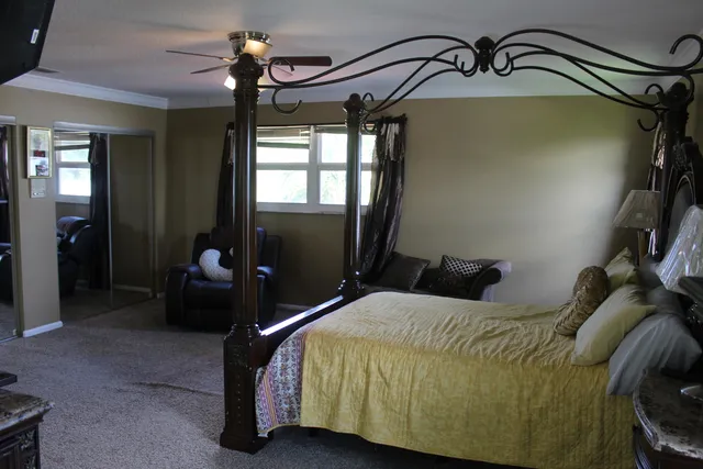 a bed room with a bed and a mirror