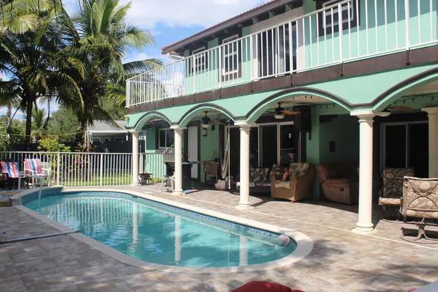 a view of a building with a swimming pool and sitting area