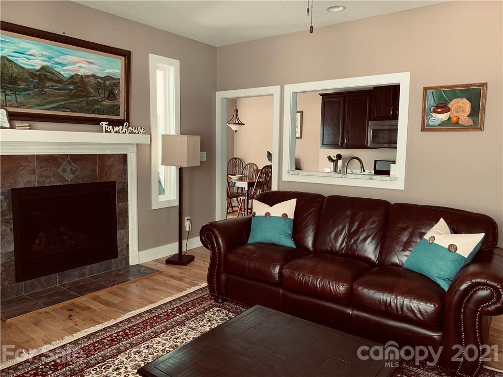 605 Souther Road Fletcher, NC 28732 - Photo 11 of 31 a living room with furniture a flat screen tv and a fireplace