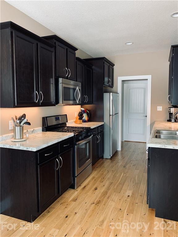 605 Souther Road Fletcher, NC 28732 - Photo 13 of 31 a kitchen with stainless steel appliances a sink stove and refrigerator