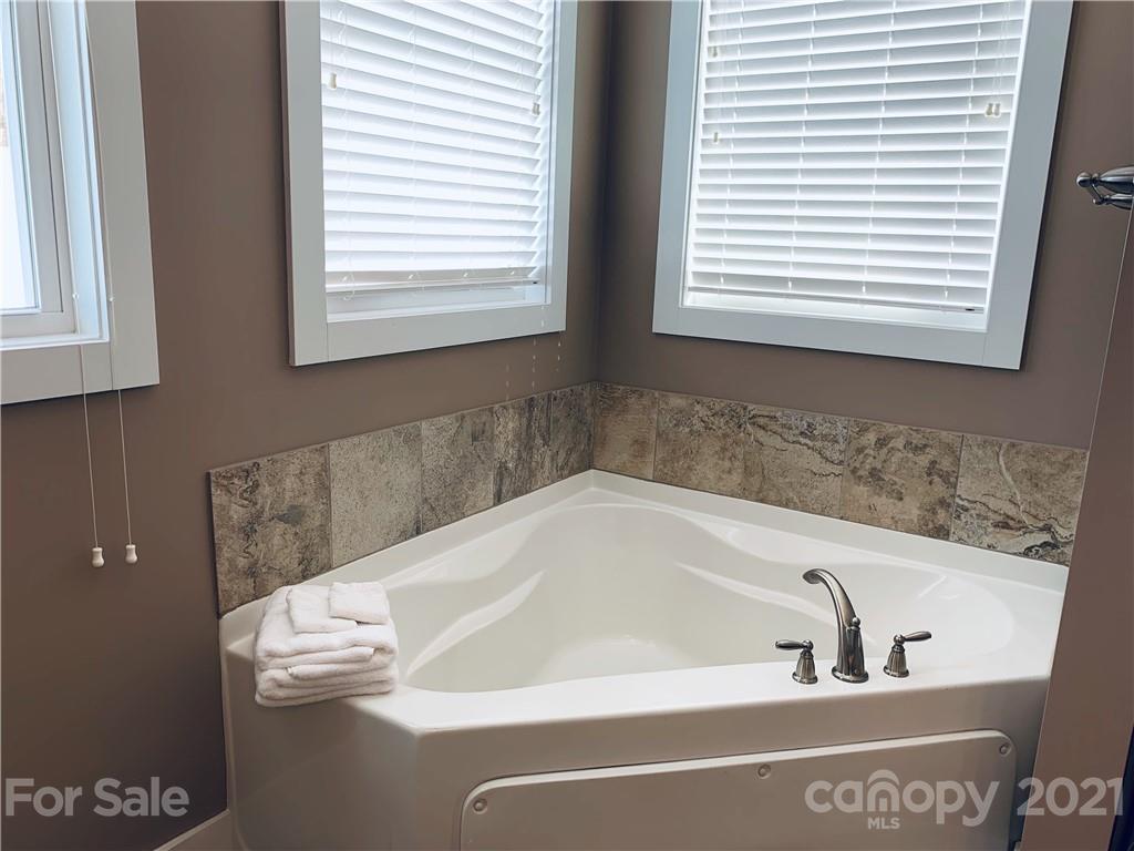 605 Souther Road Fletcher, NC 28732 - Photo 16 of 31 a bath tub sitting in a bathroom next to a window