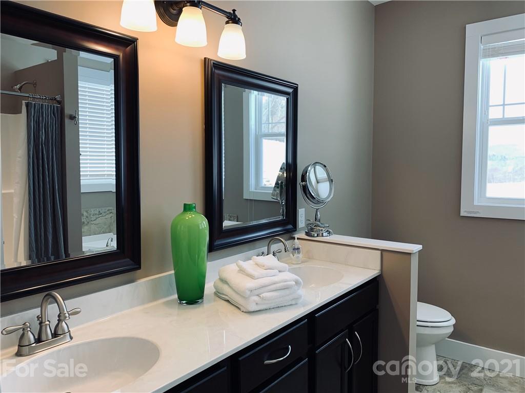 605 Souther Road Fletcher, NC 28732 - Photo 17 of 31 a bathroom with a granite countertop sink and a mirror