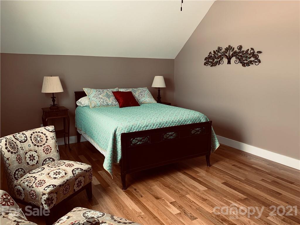 605 Souther Road Fletcher, NC 28732 - Photo 18 of 31 a bedroom with a bed and wooden floor