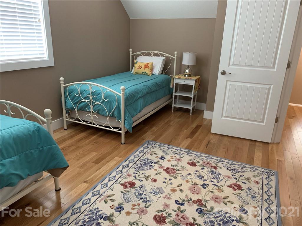 605 Souther Road Fletcher, NC 28732 - Photo 19 of 31 a bedroom with a bed and wooden floor